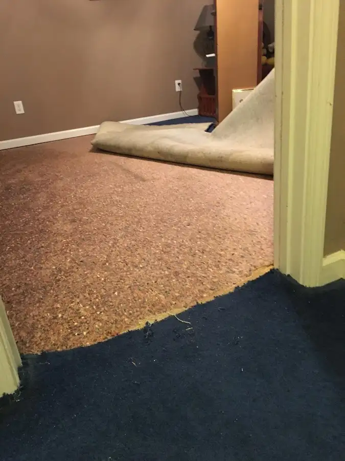 Carpet pad removal revealing water damage during Drying & Dehumidification in Deerpark