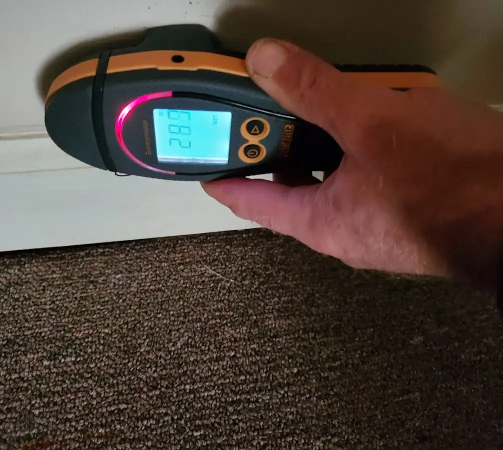 Moisture detection at baseboard during Storm Damage Restoration in Deerpark